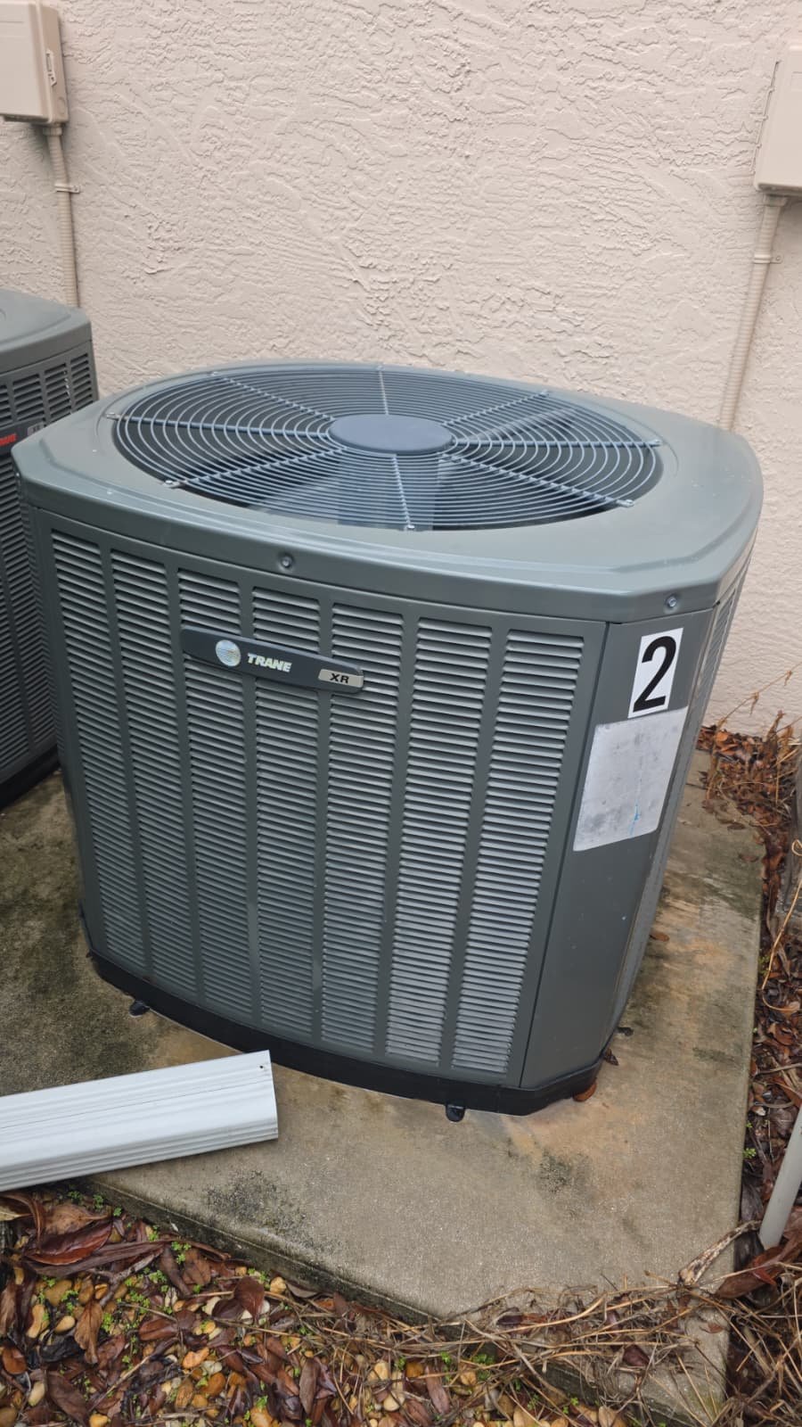 Trane AC unit installed on a concrete pad, Lakewood Ranch, FL 34202. Efficient cooling solution.