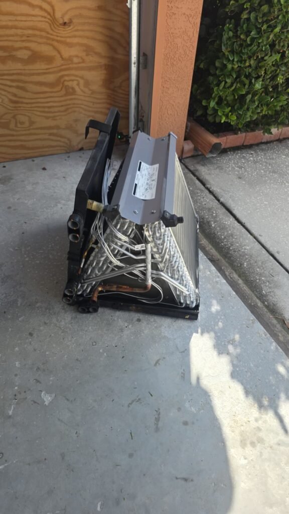 Air handler coil on the ground in a garage in Tampa, FL 33626.