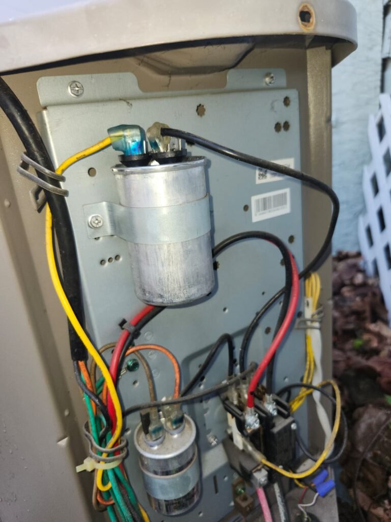 Close-up of capacitors and wiring inside an HVAC unit in Tampa, FL 33624.
