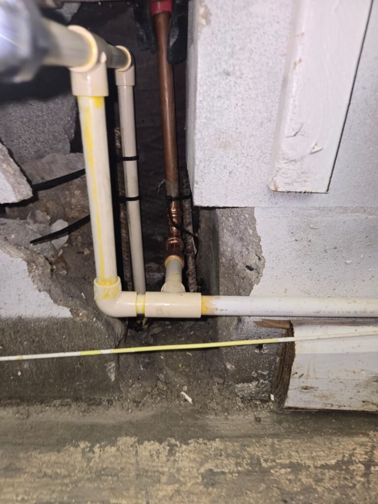 Plastic and copper supply pipes exposed at the base of an opened wall in Tampa, FL 33624.