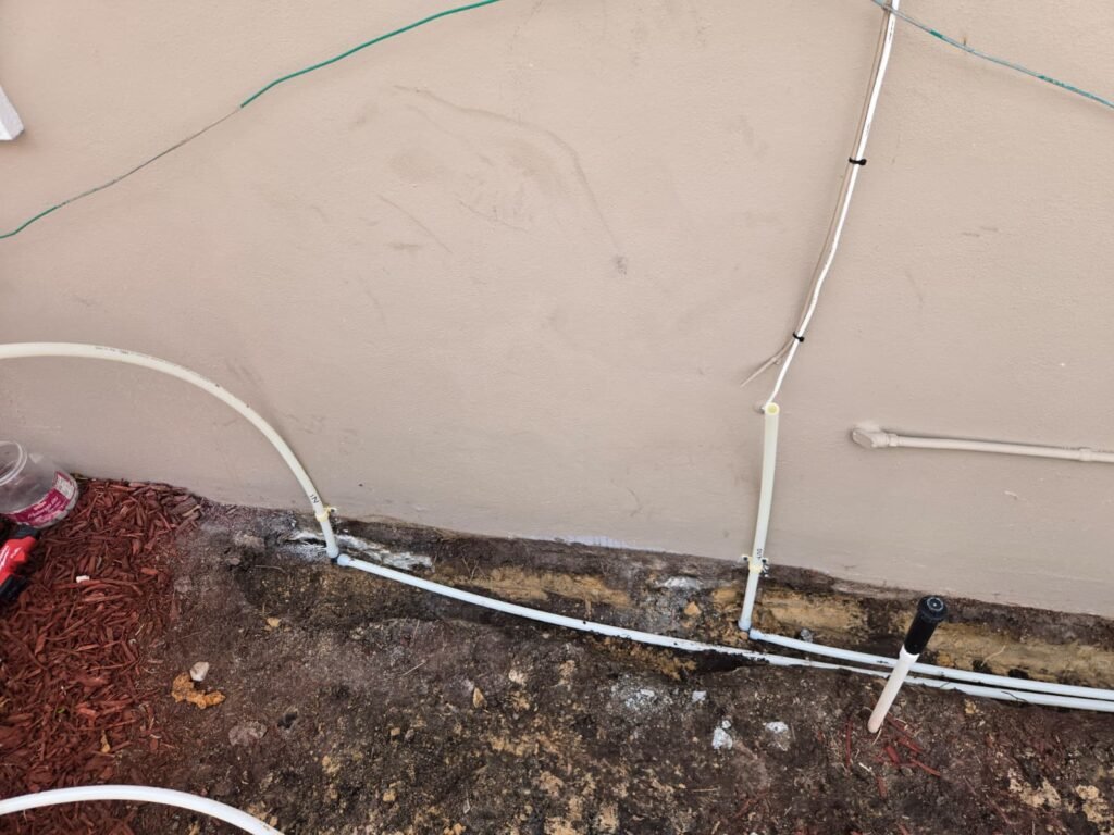 Exposed piping against house wall with some debris in New Port Richey, FL 34652.