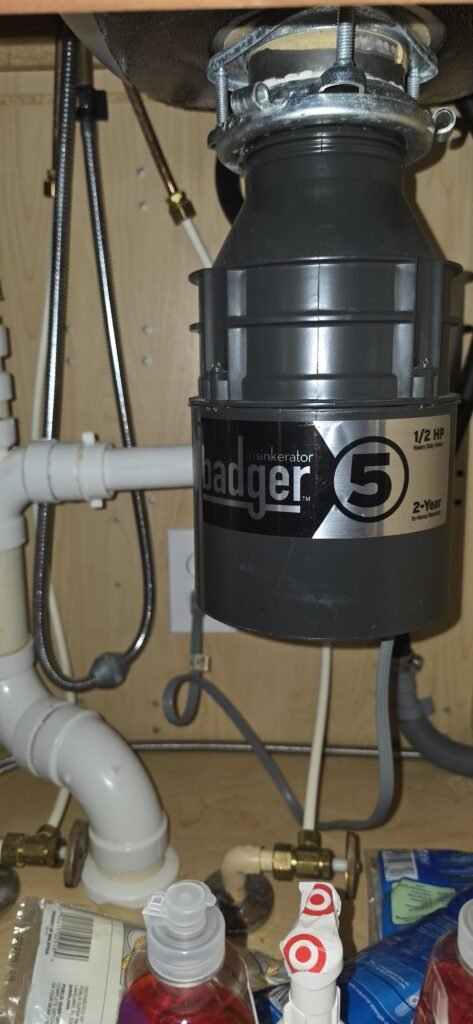 Garbage disposal unit under kitchen sink with plumbing in Riverview, FL 11433.