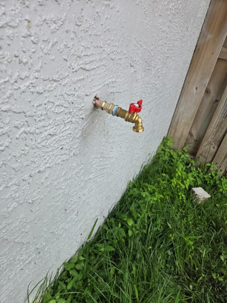 A new brass hose bib on an outside wall in Tampa, FL 33624.