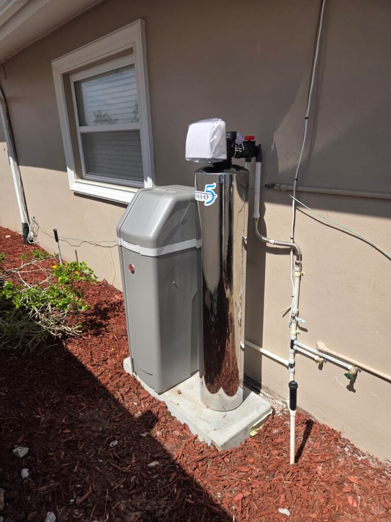 A salt-based water softener and its brine tank installed beside a home in New Port Richey, FL 34652.