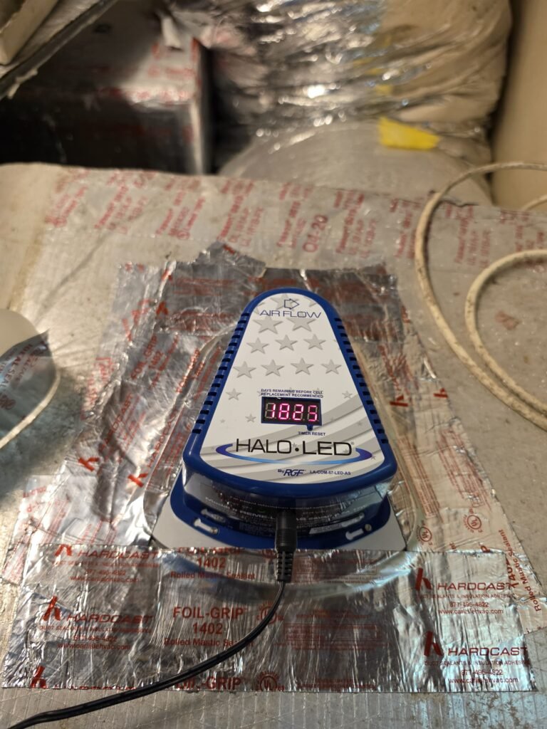 A HALO-LED unit on a foil-faced surface in an attic in Gulfport, FL 33707.