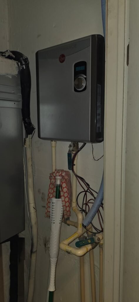 Rheem tankless water heater in utility closet, Visit #1 in St. Petersburg, FL 33702.