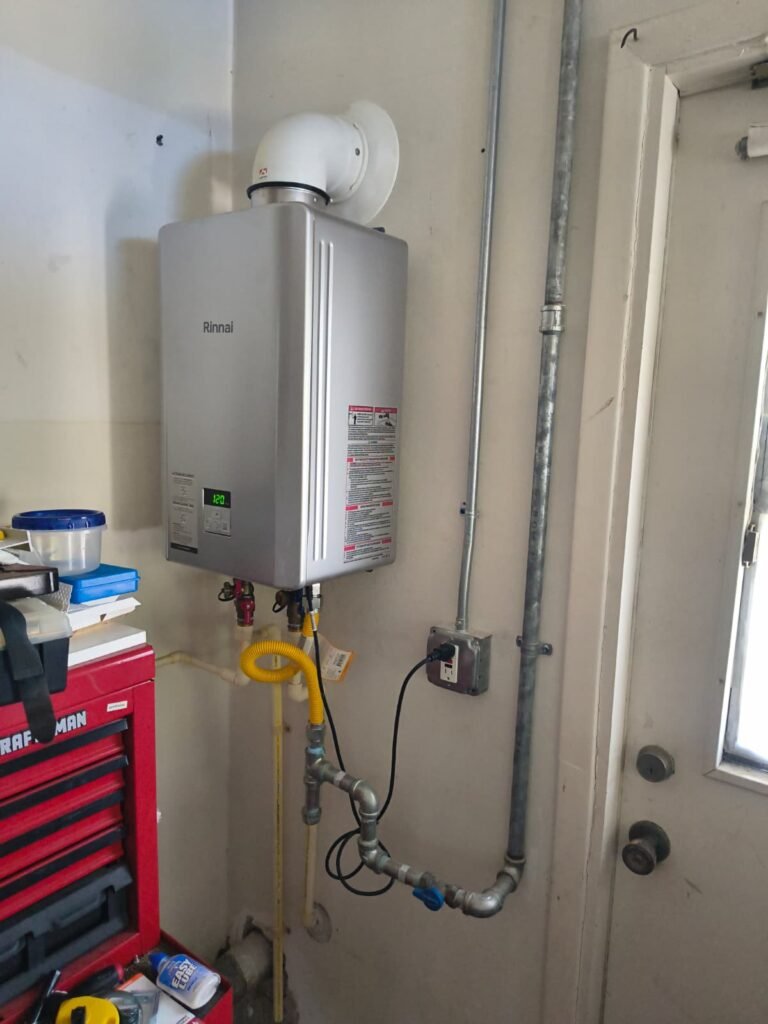 A Rinnai gas tankless water heater with its gas and water lines in Clearwater, FL 33755.