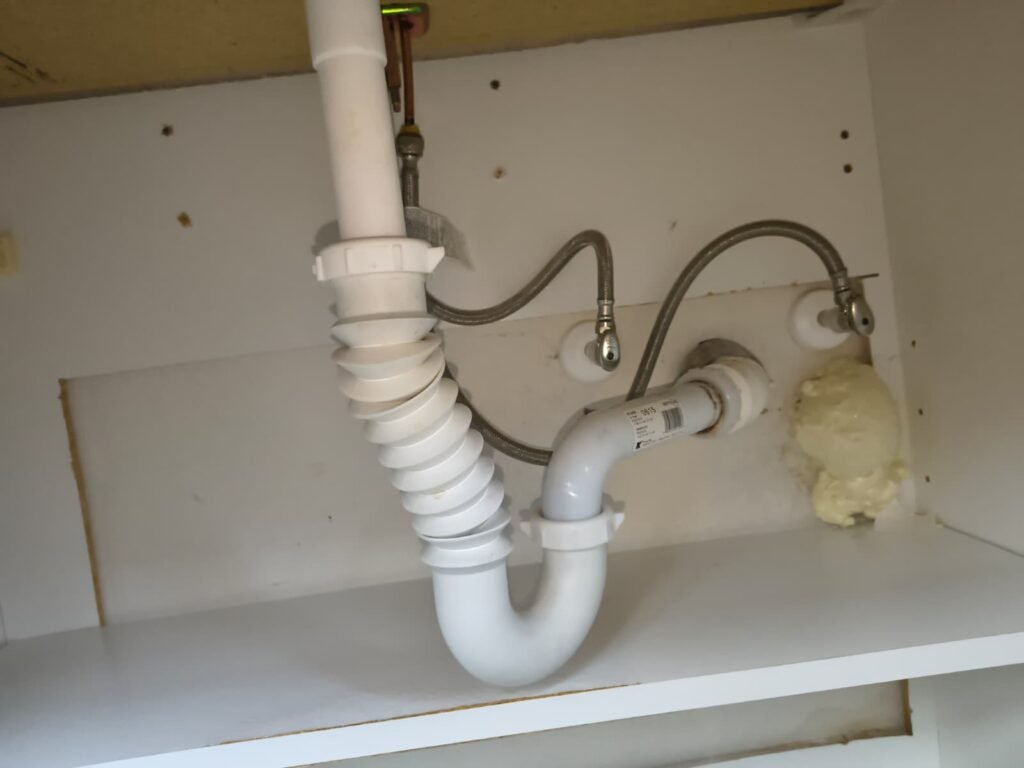 Newly installed under-sink plumbing pipes and fittings in Seffner, FL 33584. Professional toilet fill valve replacement.