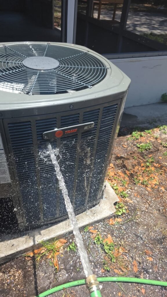 Rinsing the coil of a Trane XR condenser in Brandon, FL 33511.