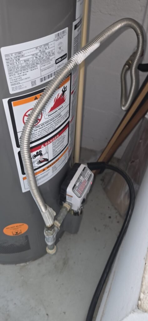 Close-up of water heater connections and labels in Riverview, FL 11433.