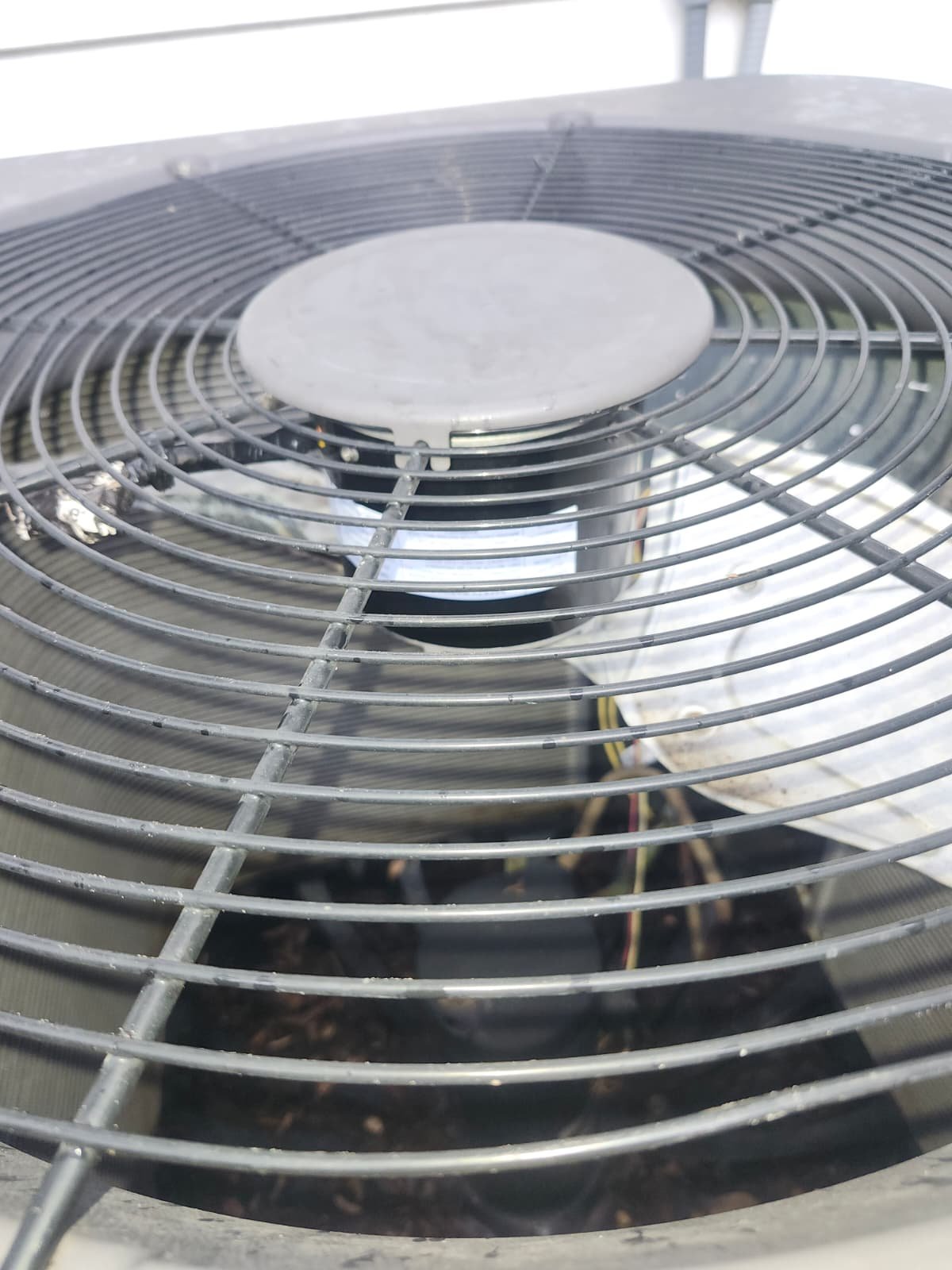Outdoor AC unit fan grill close-up in Tampa, FL 33604.