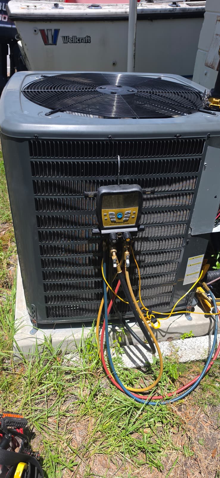 AC Unit with Gauge - Tampa, FL 33611 Goodman AC unit with manifold gauge and hoses attached in Tampa, FL 33611.