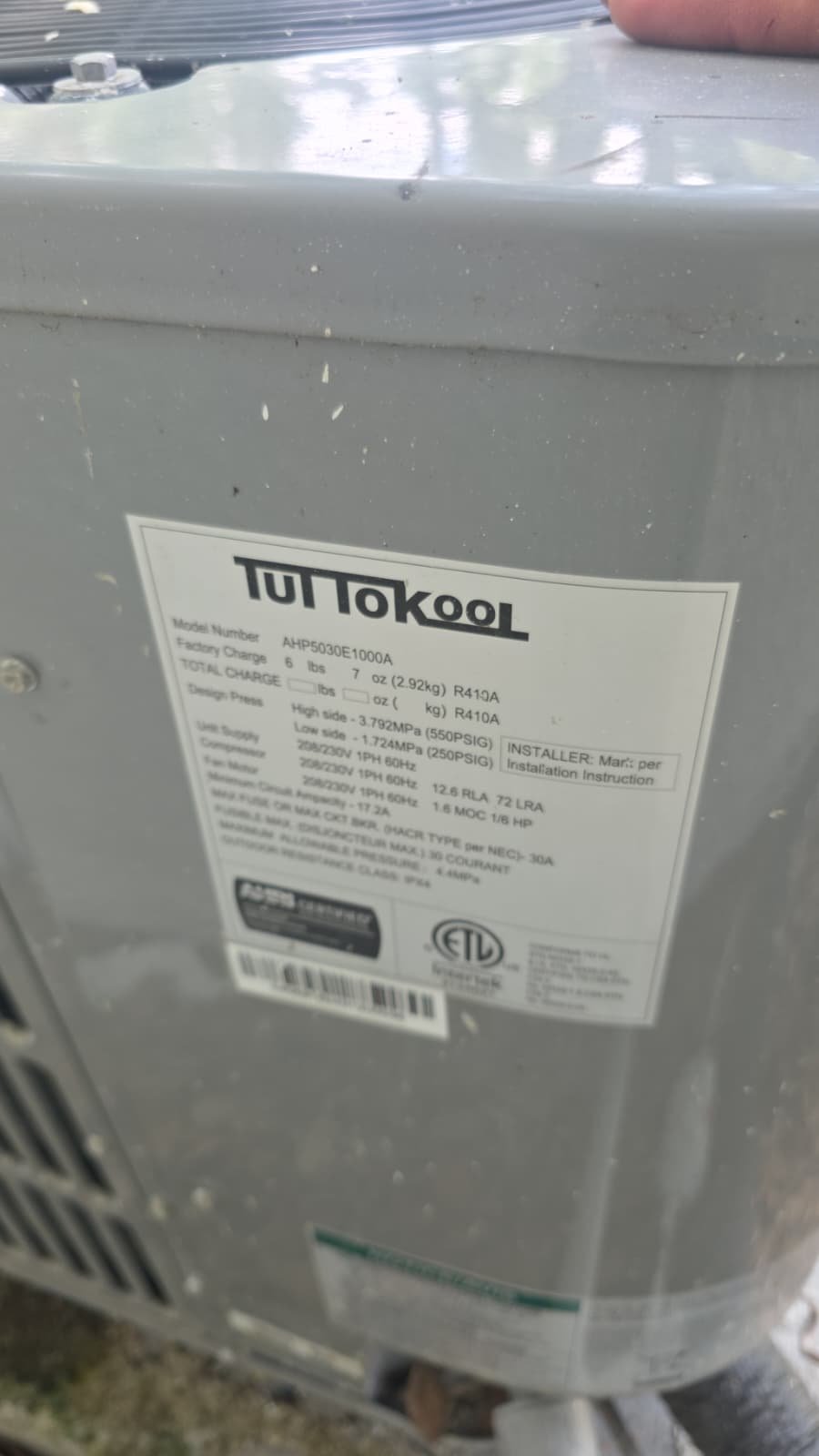 Close-up of an air conditioning unit label with specifications in Tampa, FL 33610.