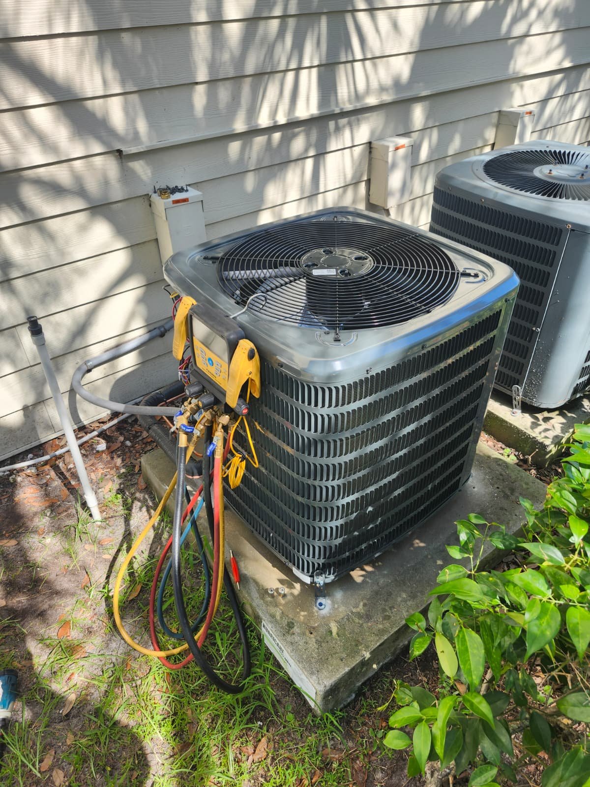 Outdoor AC unit with gauges attached for testing in Brandon, FL 33511. Accurate performance check.