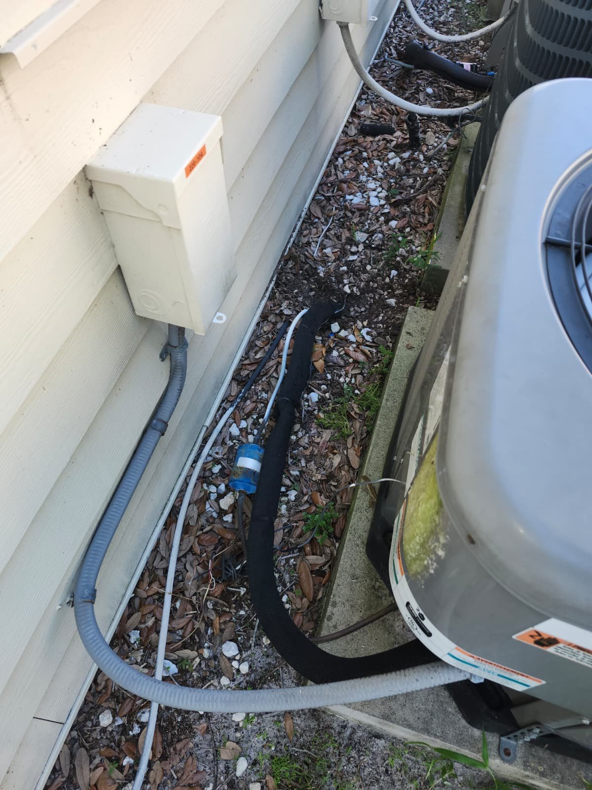 Outdoor AC unit with connected piping beside house in Brandon, FL 33511. Reliable cooling solution.