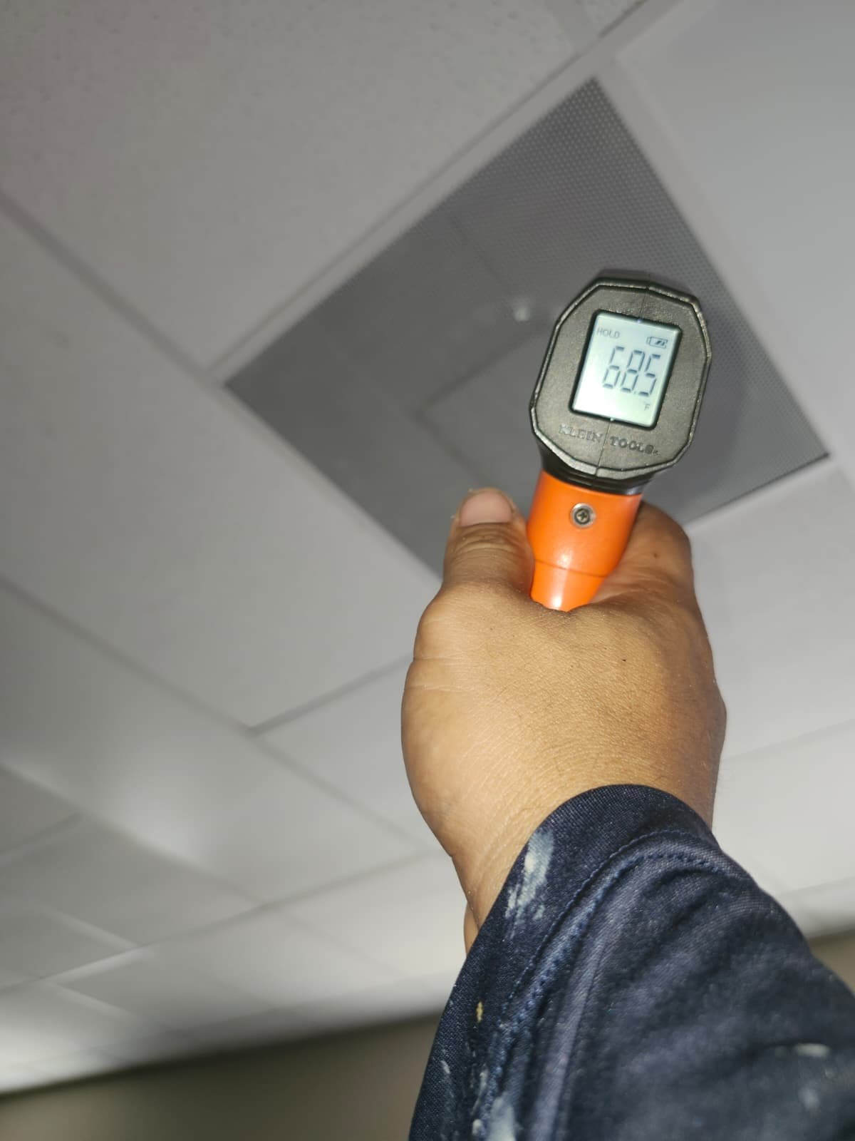 Person using a temperature gun to measure air vent output, New Port Richey, FL 34655.