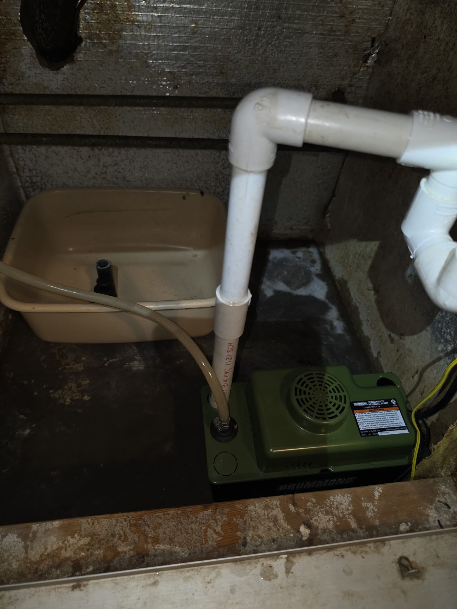 Installed condensate pump in a basement corner in Hudson, FL 34667.