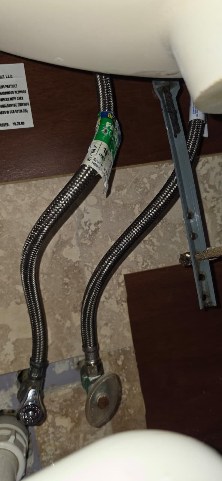 Braided Supply Lines Under Sink - Tampa, FL 33624 Braided supply lines under sink in Tampa, FL 33624. In-progress repair view.