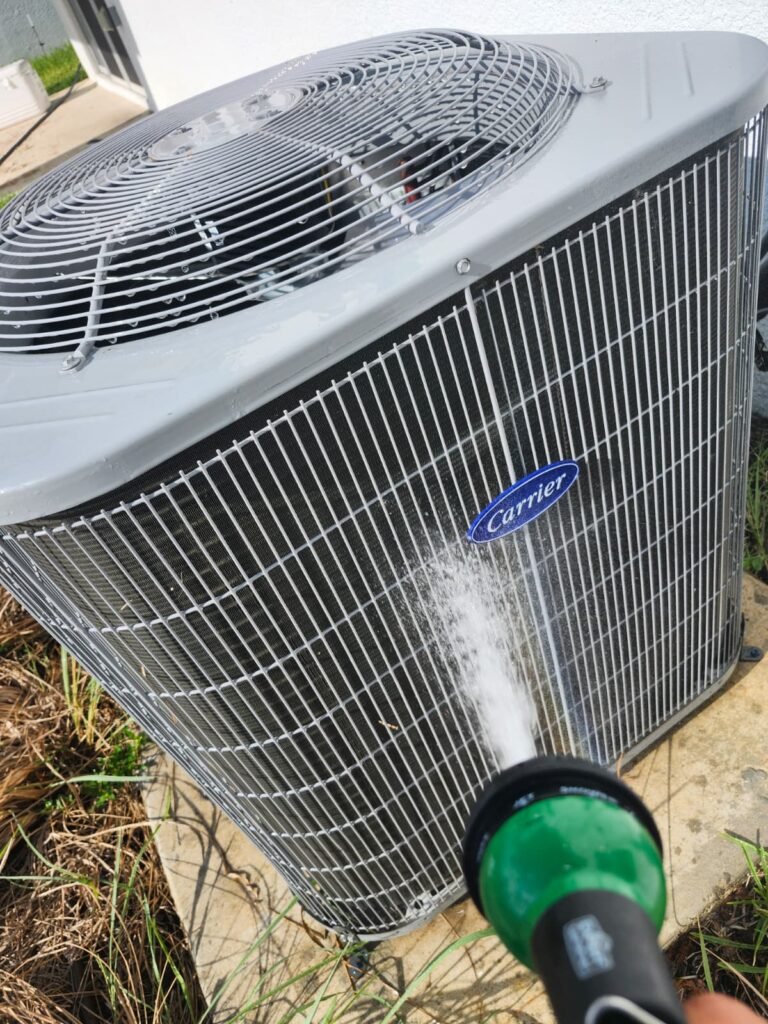 Rinsing the outdoor coil of a Carrier unit in Apollo Beach, FL 33572.