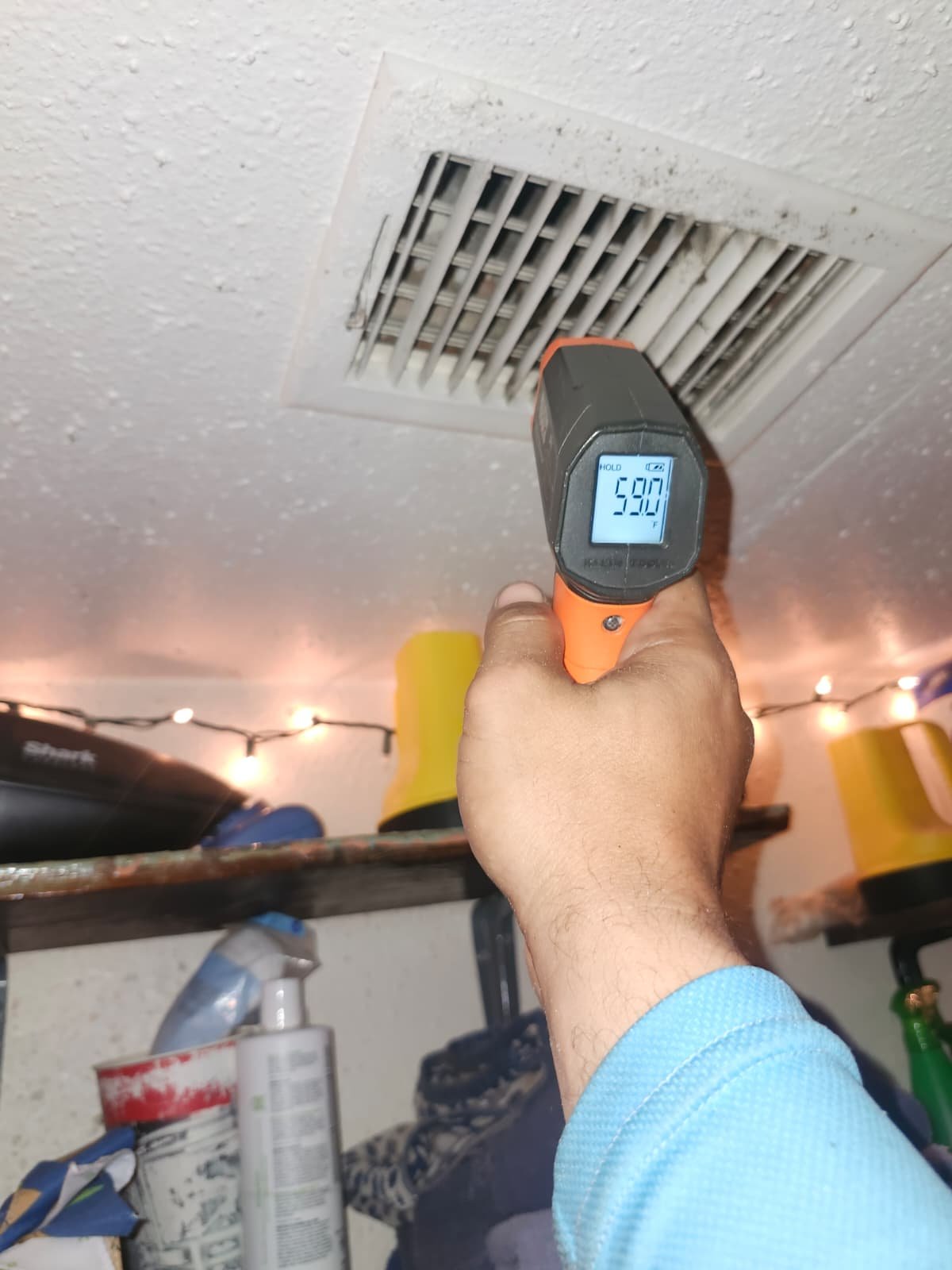 Thermometer reading at ceiling air vent in Tampa, FL 33604.