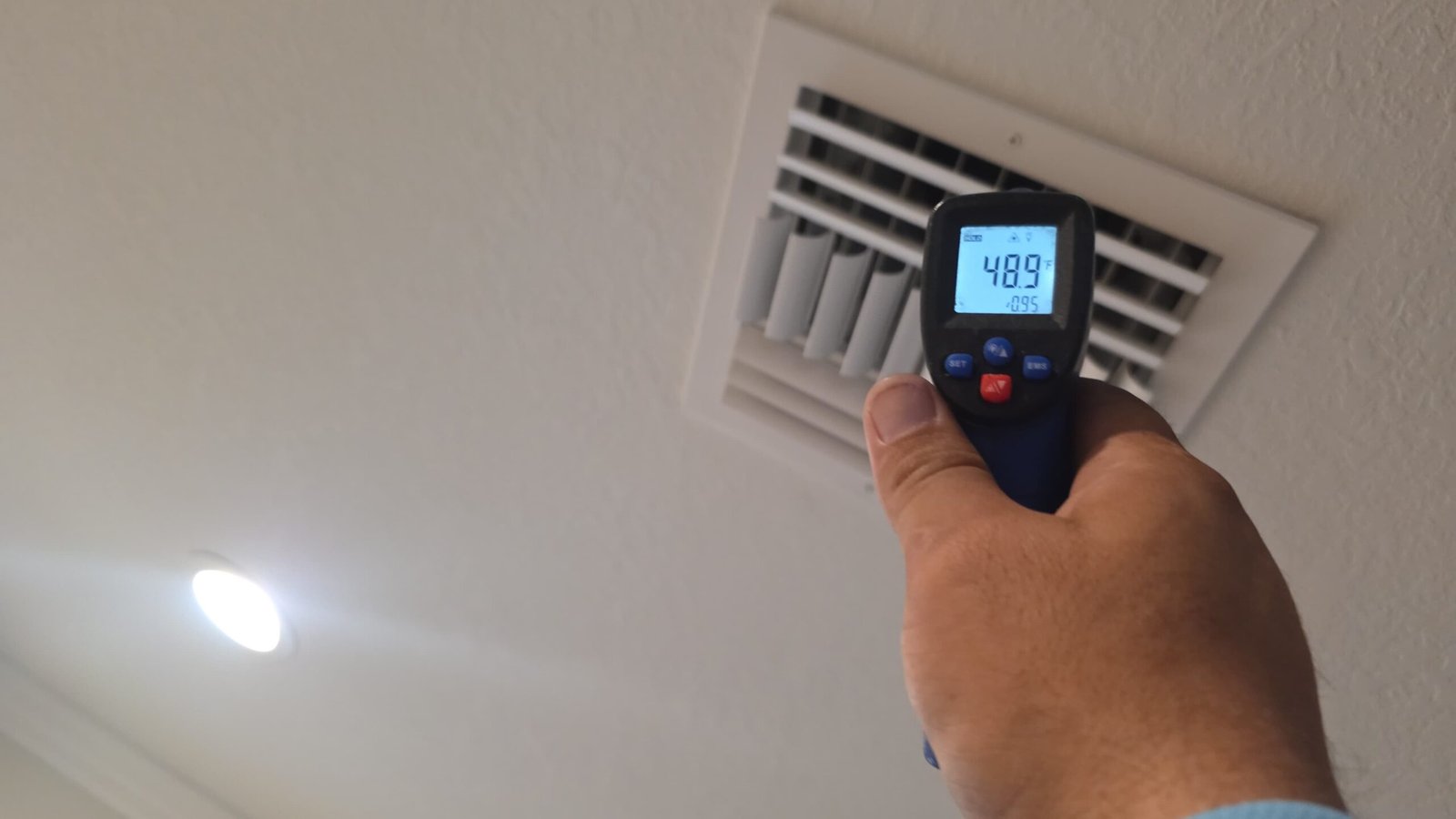 Temperature reading at ceiling vent with digital thermometer in Palm Harbor, FL 34684 during Premium Therapy Plan 2.0.