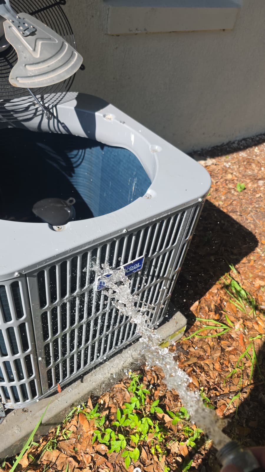 Cleaned exterior of an HVAC unit with water spray in Tampa, FL 33610.