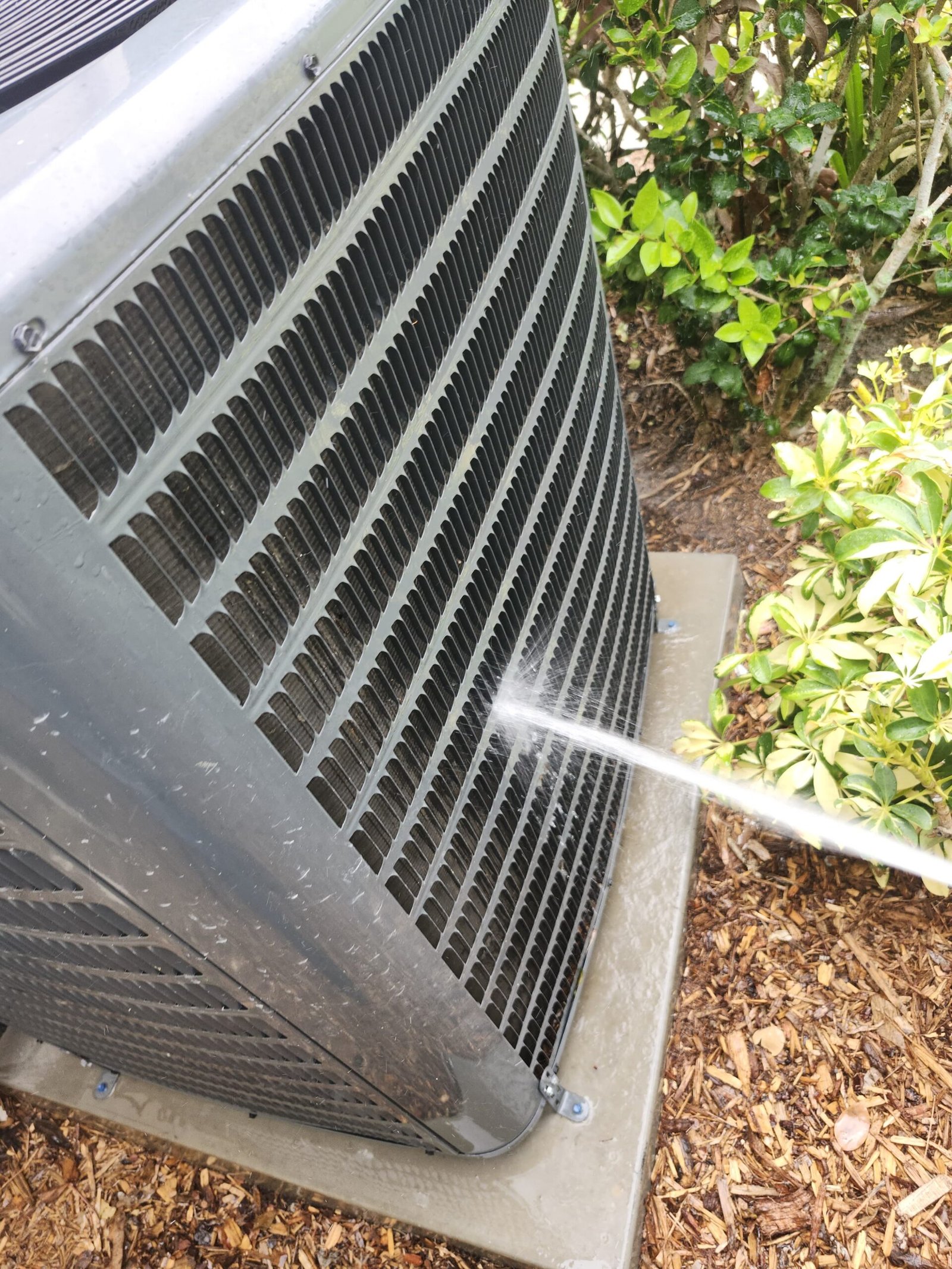 Cleaning Outdoor AC Unit - Palm Harbor, FL 34684 Cleaning outdoor AC unit with water spray, Visit #4, Palm Harbor, FL 34684.