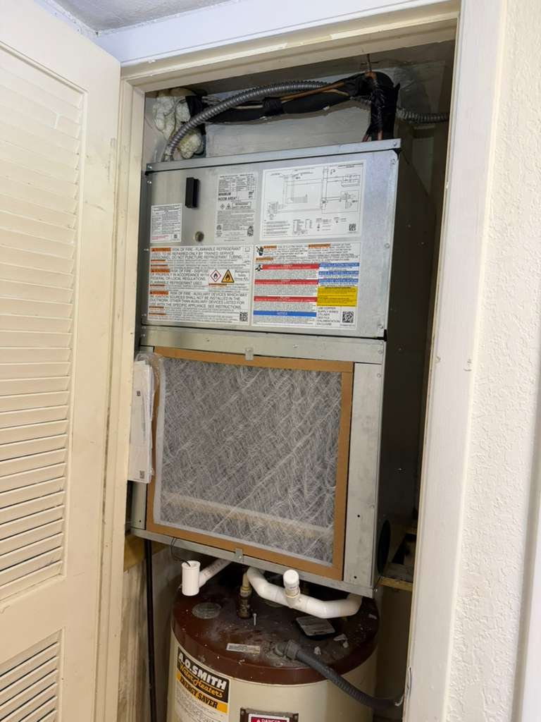 Completed HVAC installation above water heater in Tampa, FL 33618.