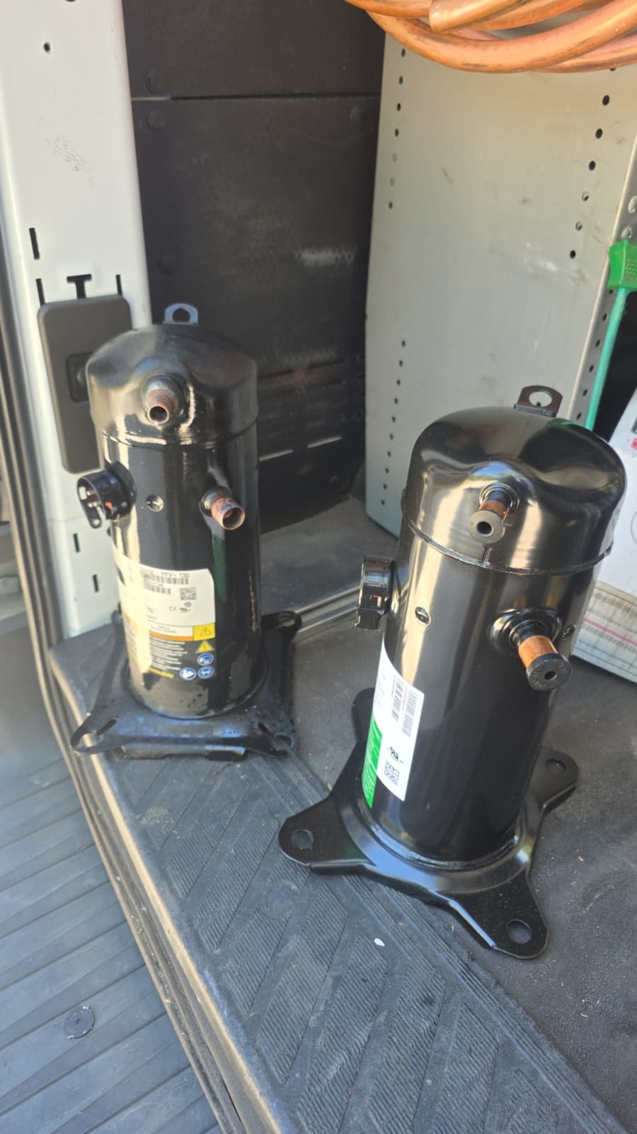 Compressors Ready for Installation - Lutz, FL 33558 Two compressors placed on a van floor in Lutz, FL 33558.