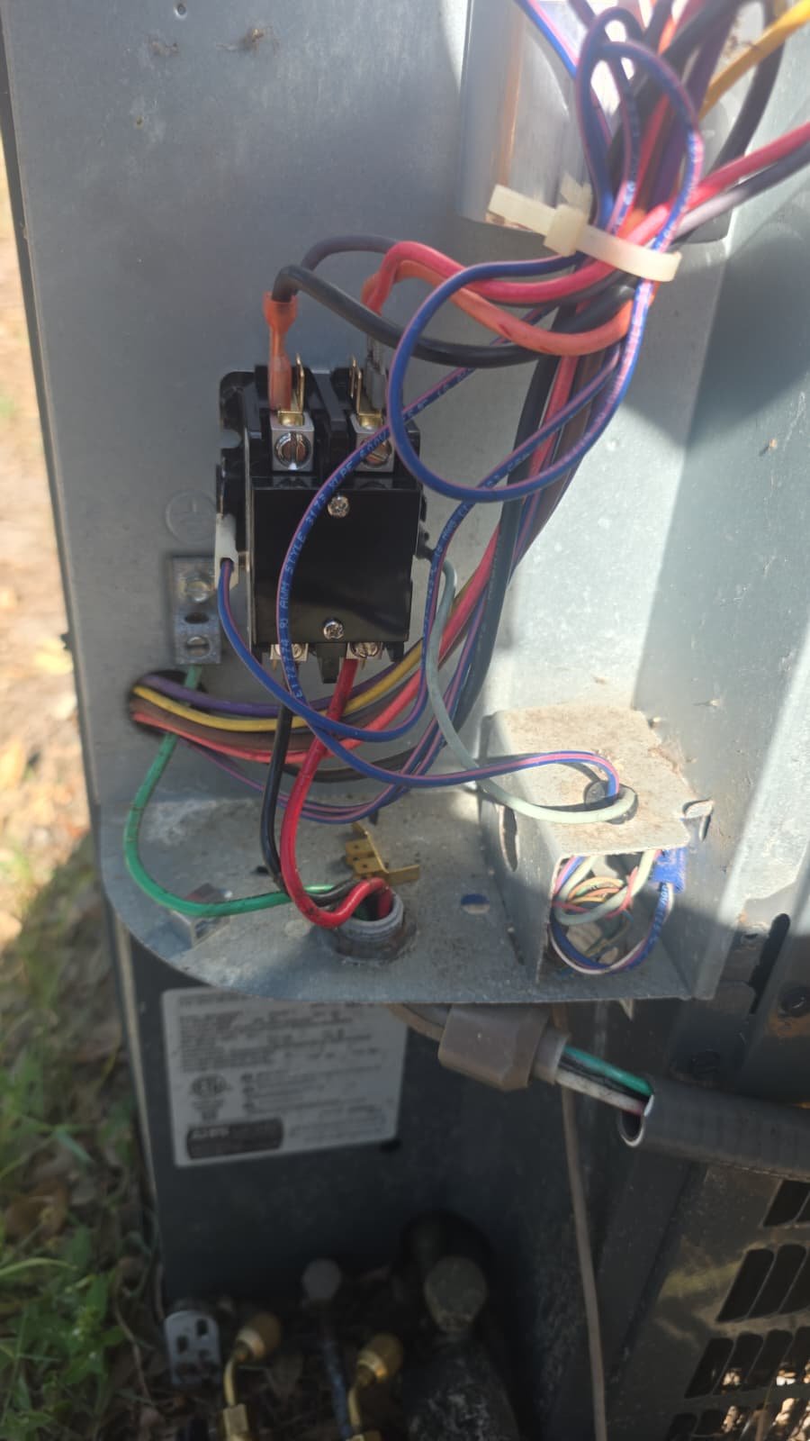 Wiring and contactor installation inside AC unit in Tampa, FL 33611. In-progress HVAC service.