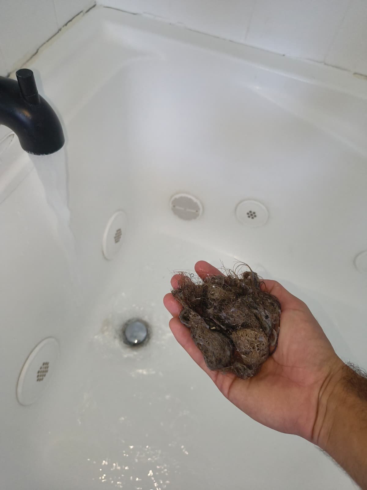 Drain Unclogging in Brandon, FL 33511 Removing hair clog from bathtub drain in Brandon, FL 33511.
