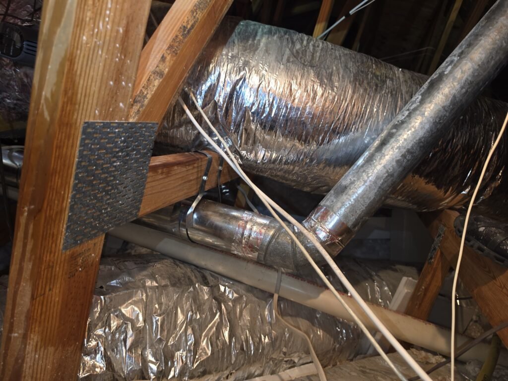 A rigid dryer duct run through an attic during an install in Tampa, FL 33647.
