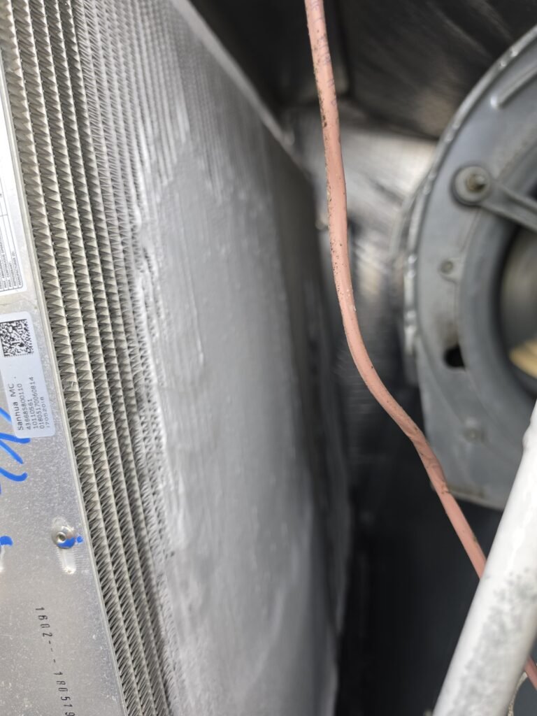 Frost built up across an evaporator coil inside an air handler in Tampa, FL 33634.
