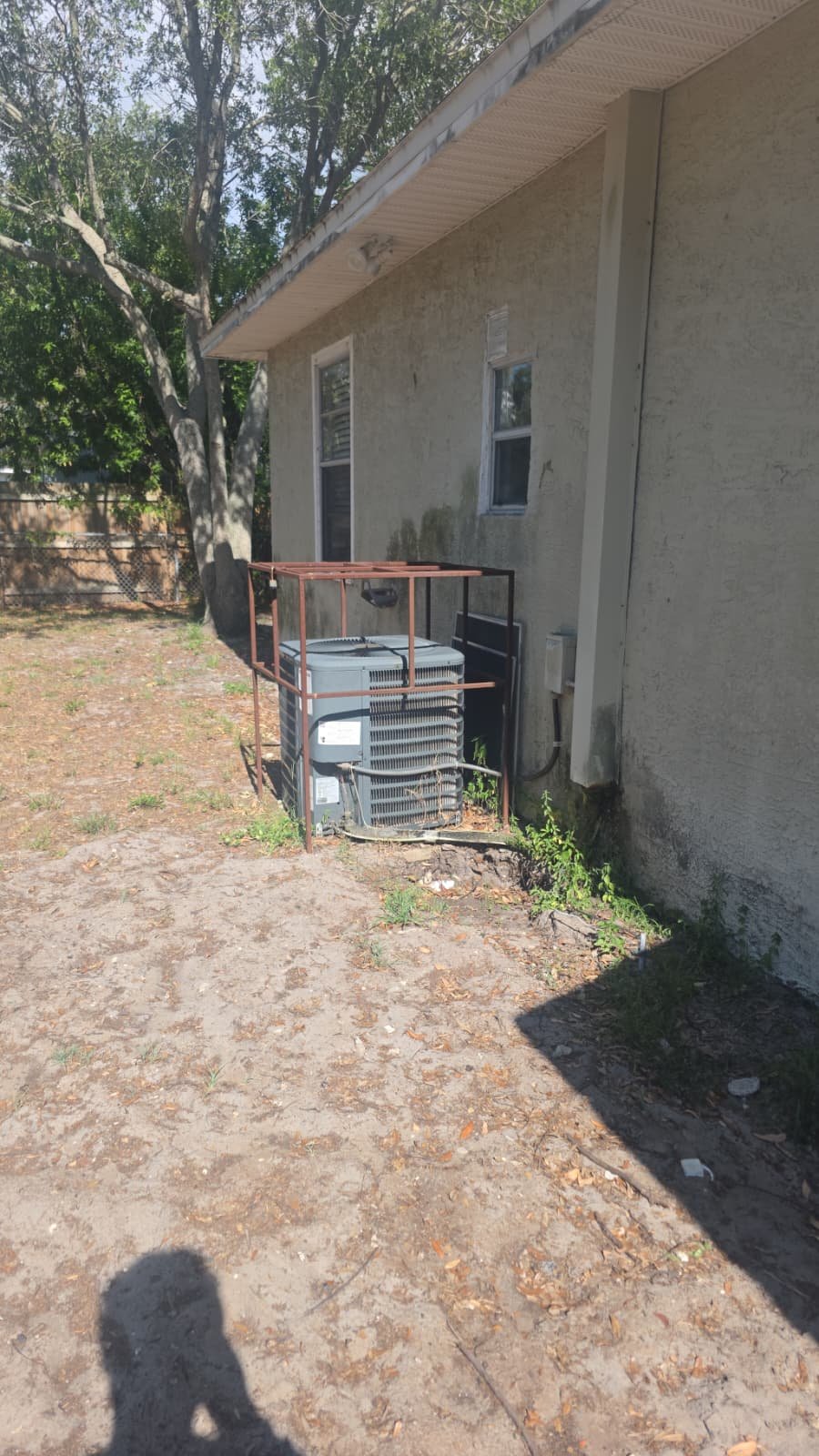 Exterior view of AC unit installed beside a house in Tampa, FL 33611.