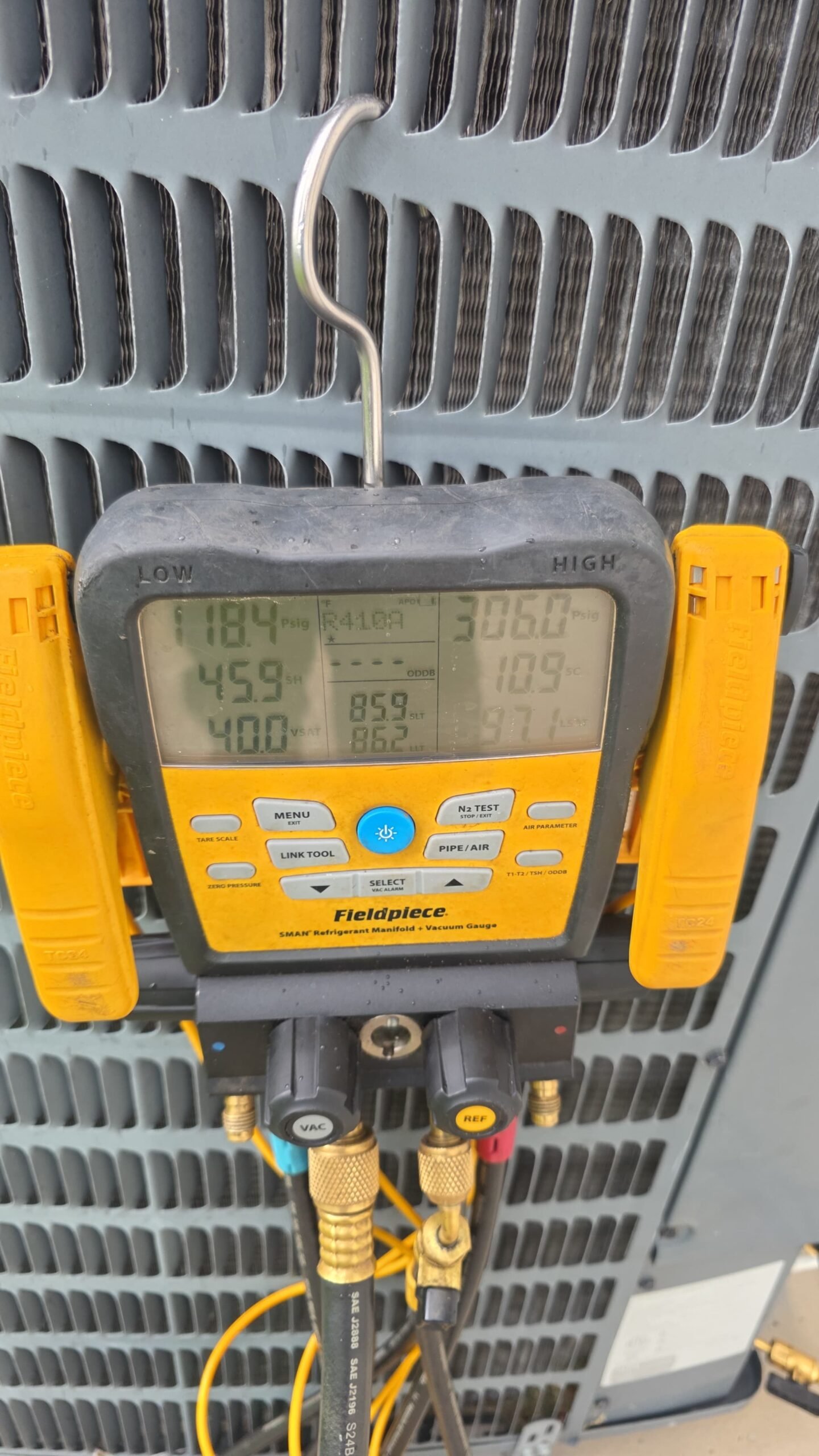 Fieldpiece digital manifold gauge set attached to HVAC unit in Palm Harbor, FL 34684 during Premium Therapy Plan 2.0.