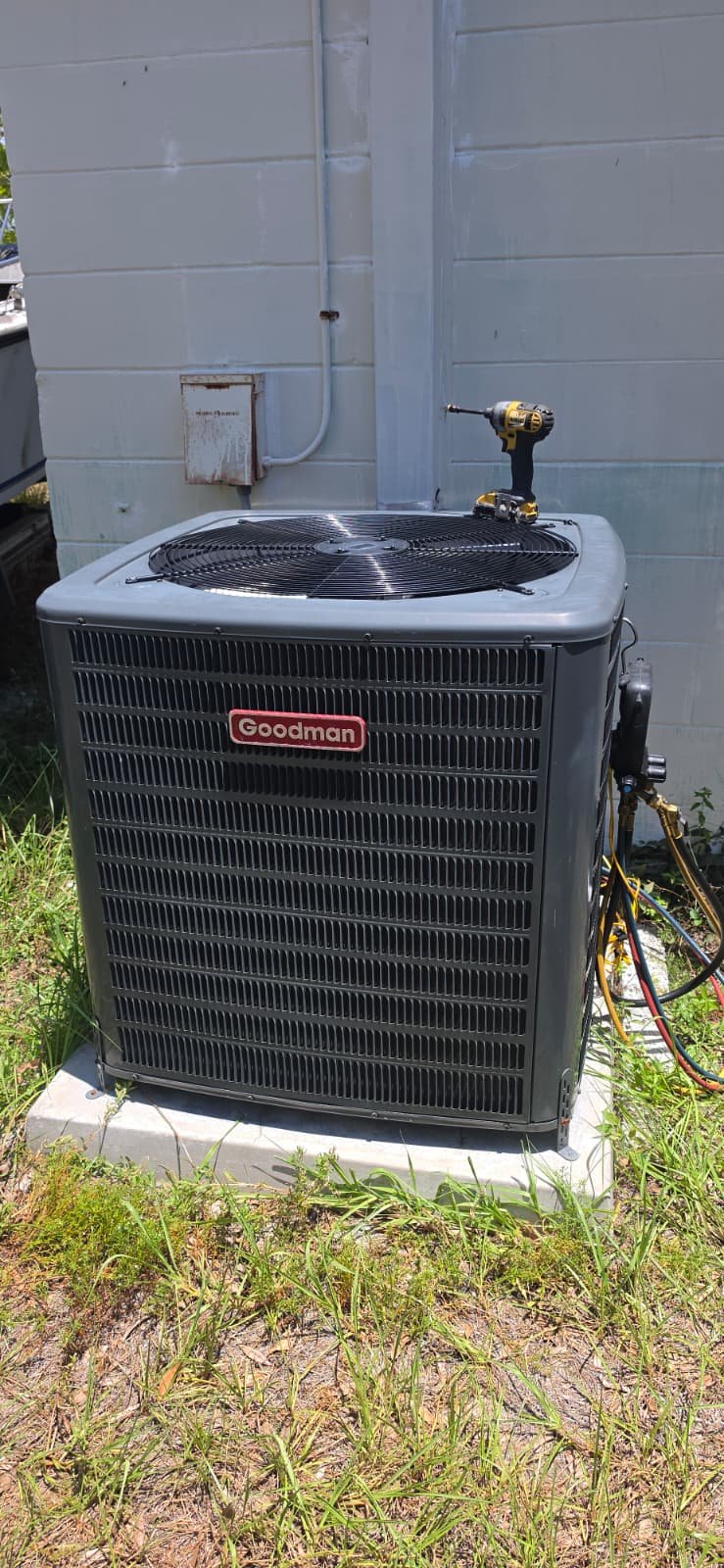 Goodman AC Installation - Tampa, FL 33611 Newly installed Goodman AC unit on a concrete pad in Tampa, FL 33611.