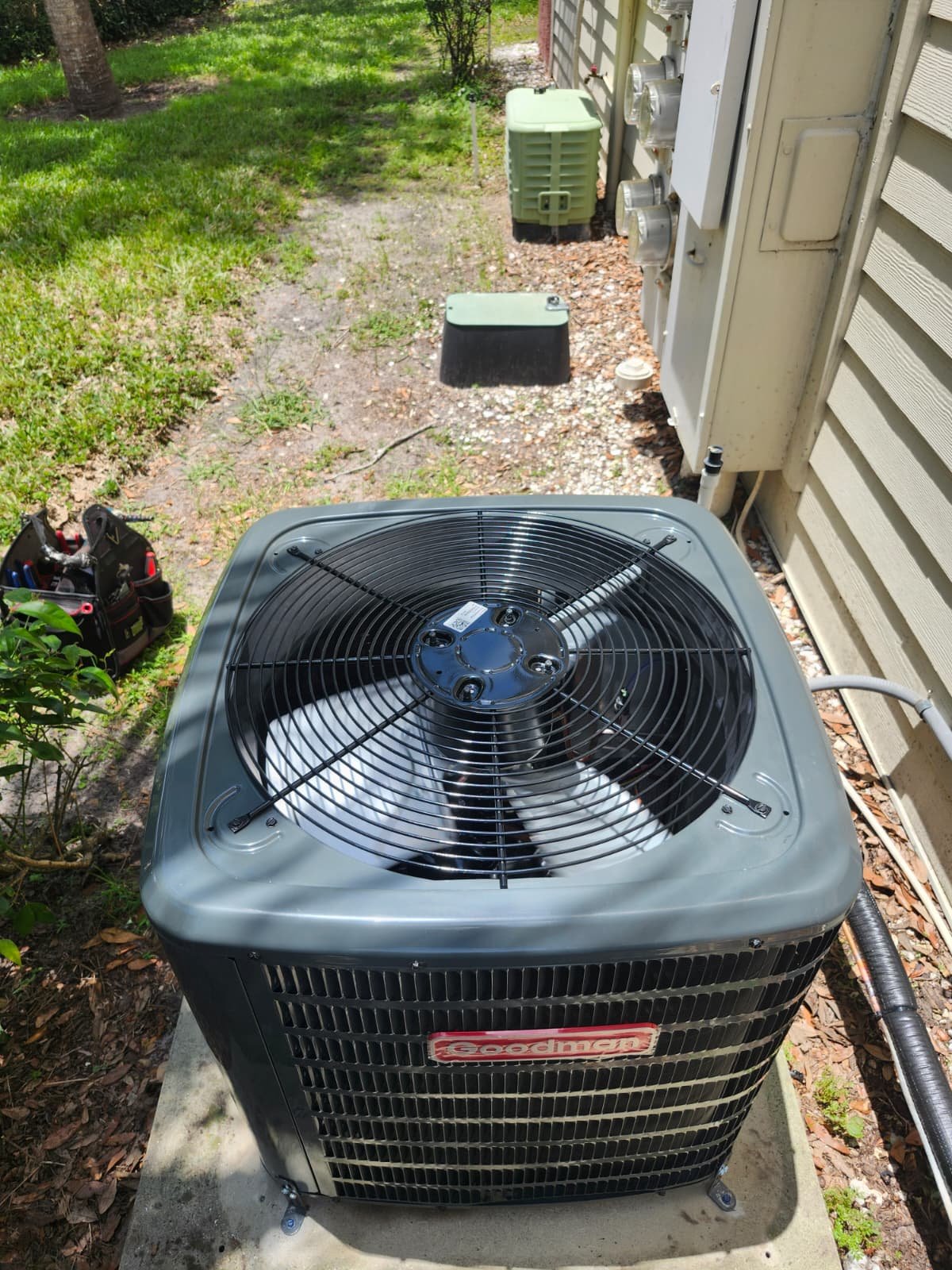 Goodman AC unit installed outside on a concrete pad in Brandon, FL 33511. Durable installation.
