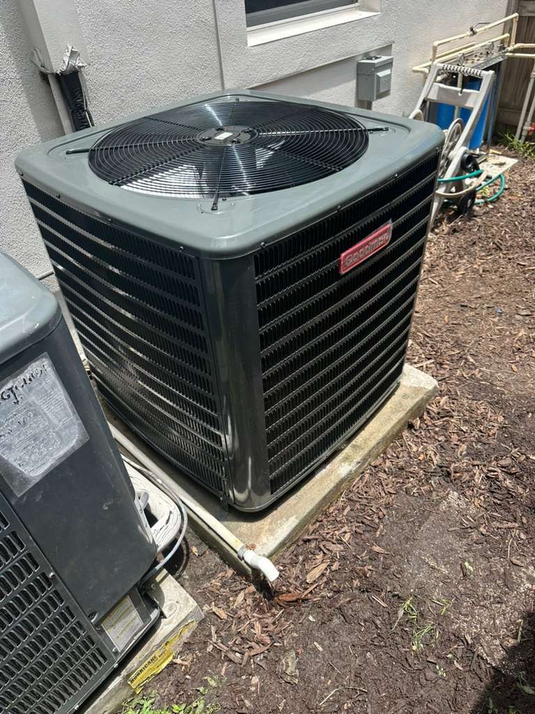A Goodman condenser on a pad beside a home in Tampa, FL 33629.