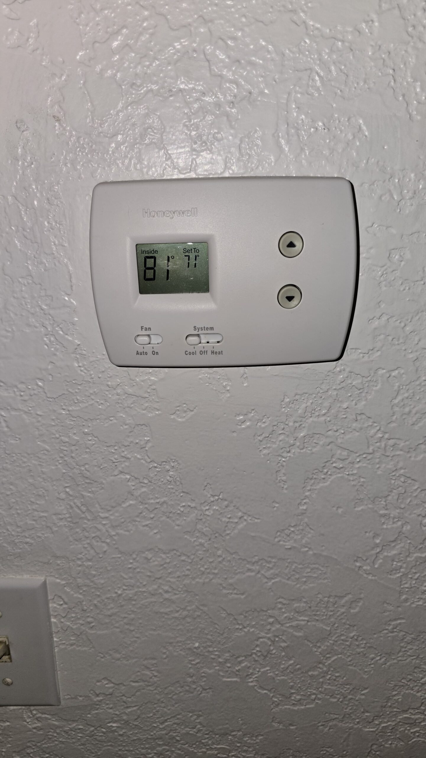 Installed Honeywell thermostat displaying temperature in Tampa, FL 33618.