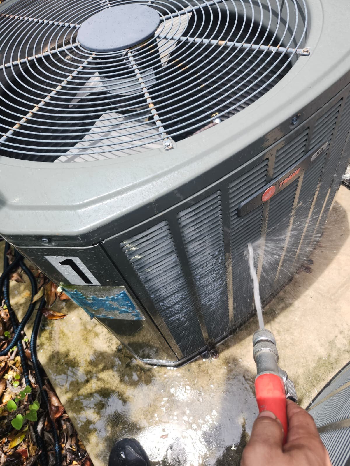 HVAC Unit Cleaning - Lakewood Ranch, FL 34202 Cleaning an HVAC unit with a hose in Lakewood Ranch, FL 34202.