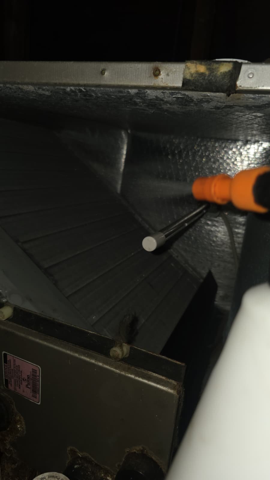 Close-up of HVAC component with tool inserted in St. Petersburg, FL 33703.