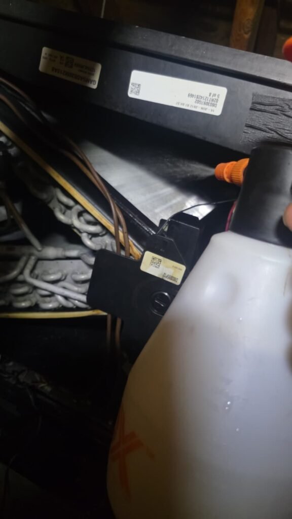 Close-up of HVAC components with spray bottle in St. Petersburg, FL 33703.