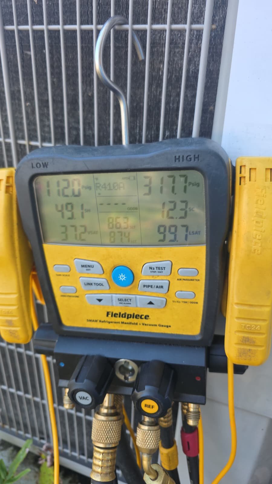 Close-up of HVAC diagnostic tools with readings in St. Petersburg, FL 33703.