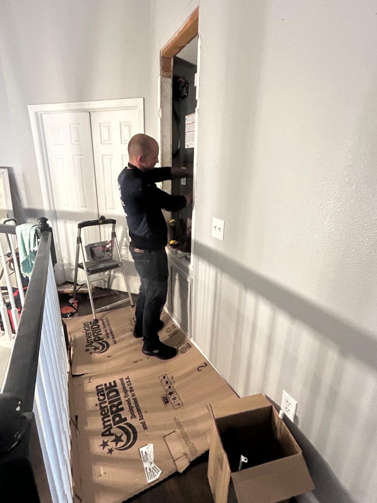 Technician working on HVAC installation, Oldsmar, FL 34677.