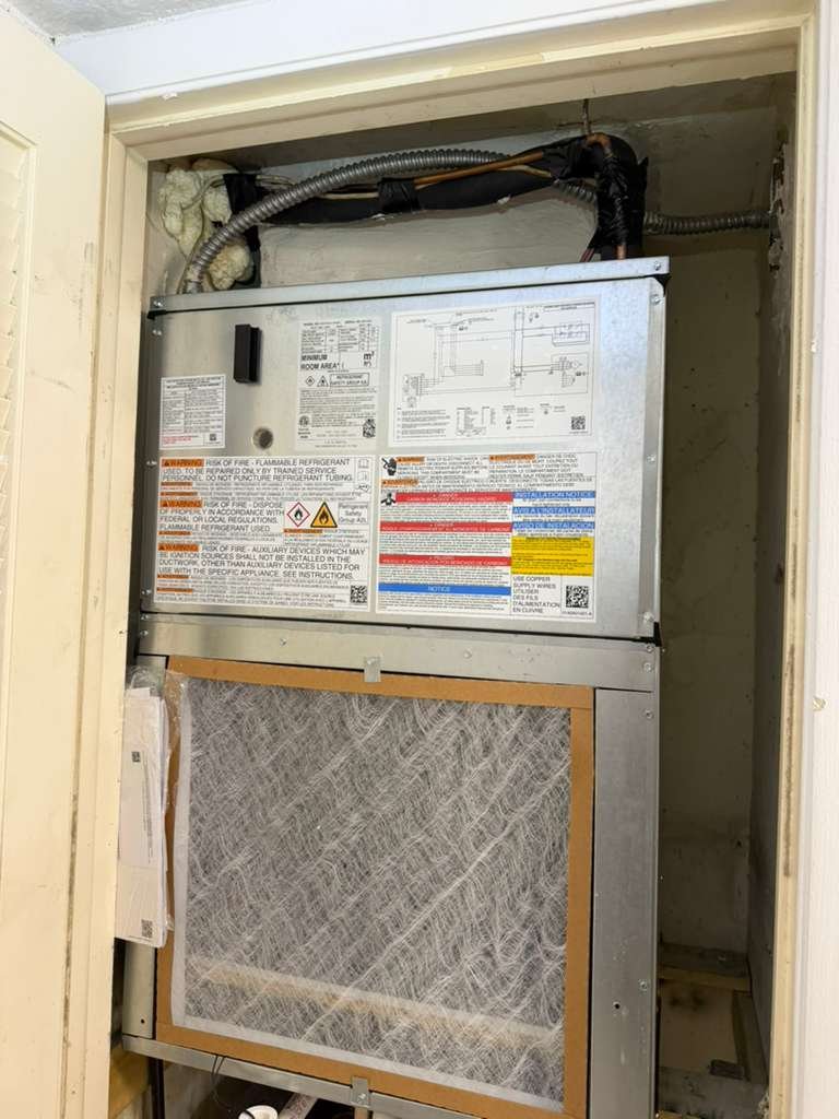 Interior view of HVAC system with labels and filters in Tampa, FL 33618.