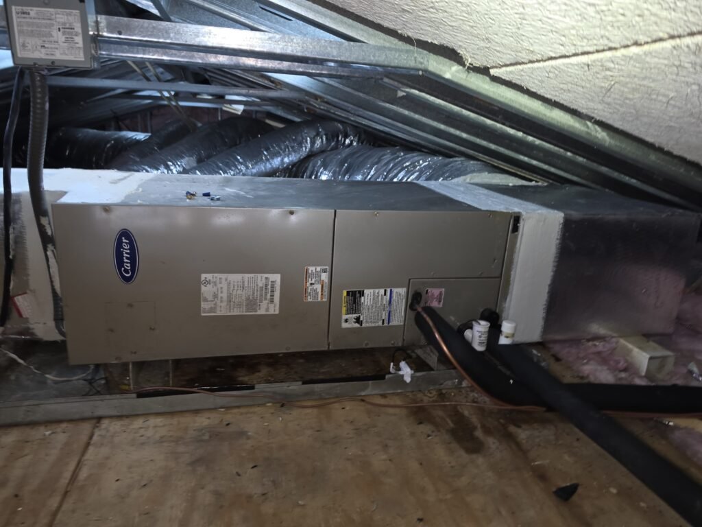 A horizontal air handler with its plenum box on the end, in an attic in Lutz, FL 33549.