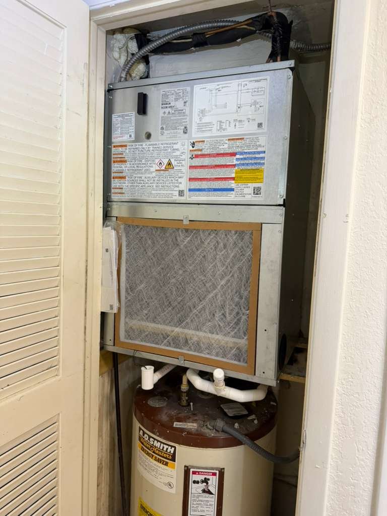Completed HVAC installation above water heater in Tampa, FL 33618.