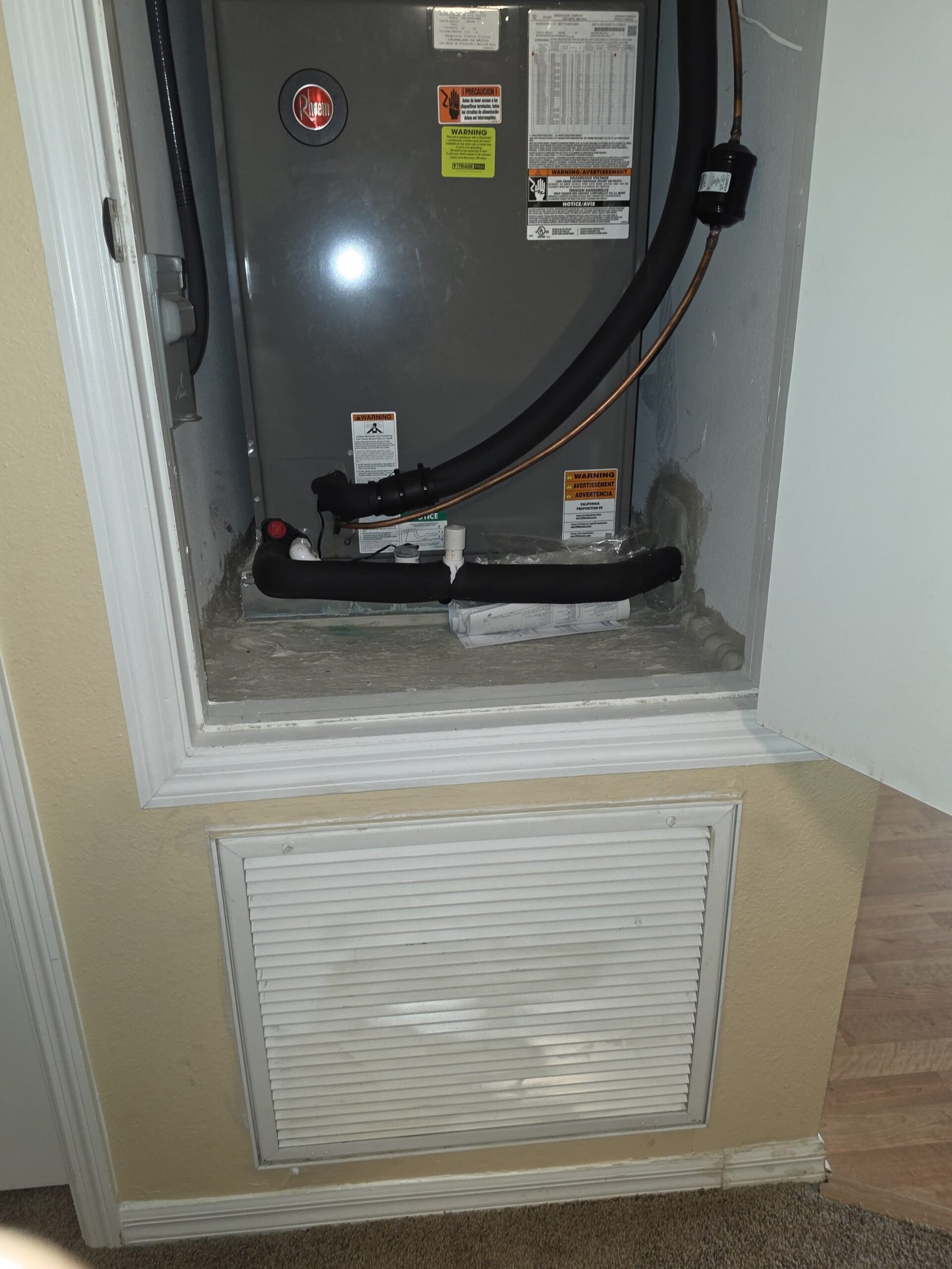 HVAC unit with vent cover and open door in Lutz, FL 33558.