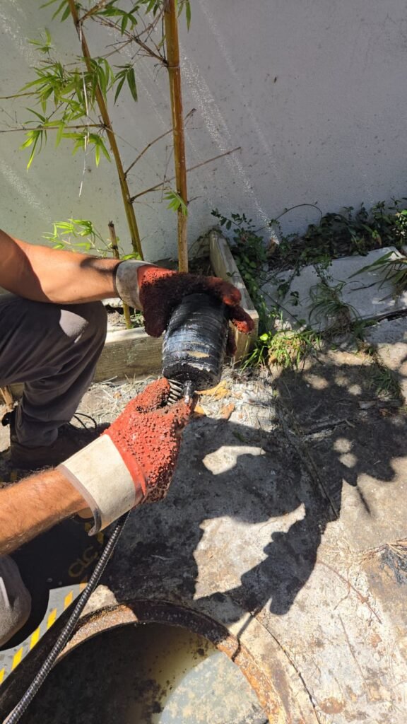 Feeding a hydro jet hose into a sewer cleanout in St. Petersburg, FL 33701.