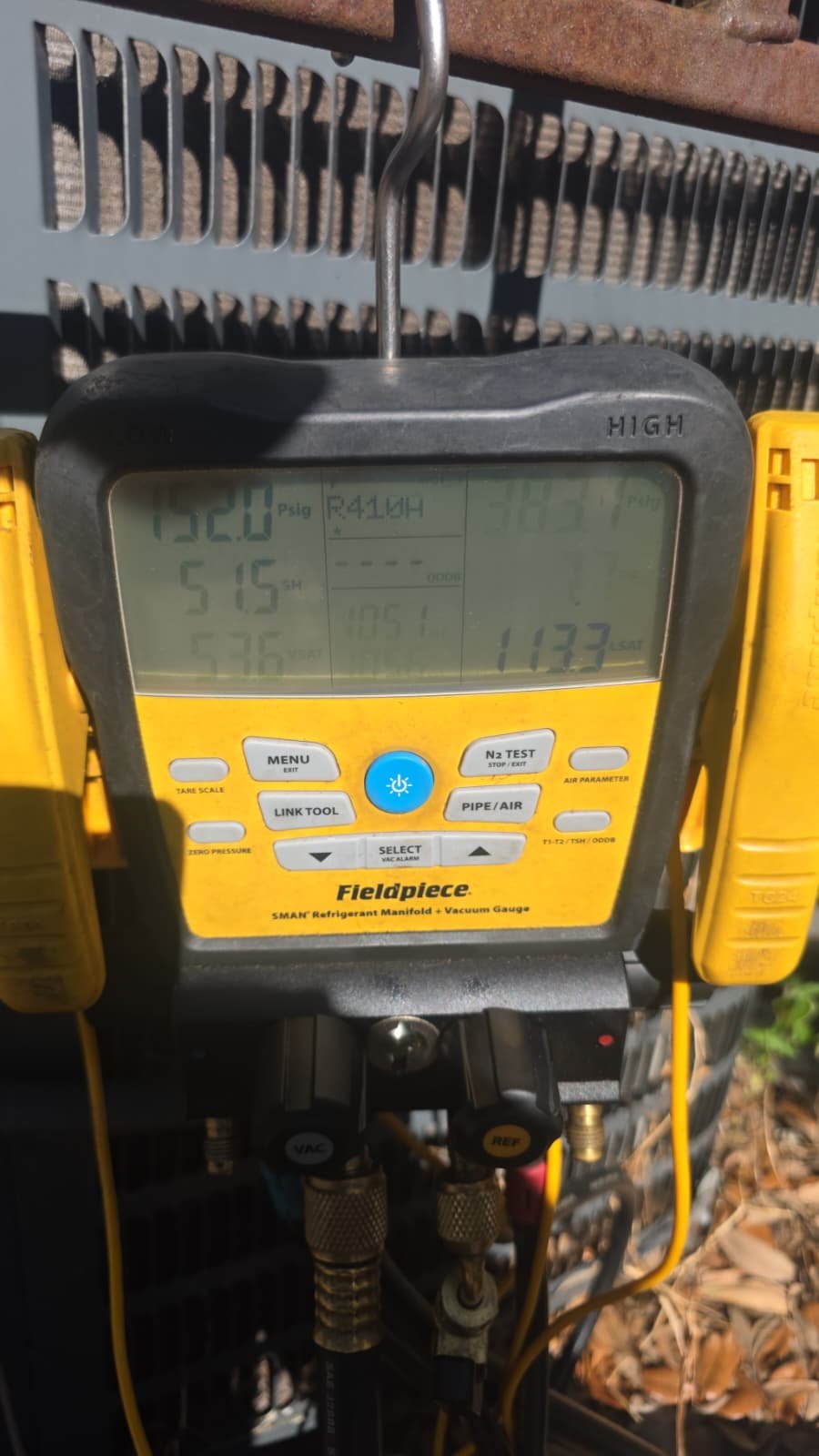 Digital manifold gauge displaying pressure readings on AC unit in Tampa, FL 33611.
